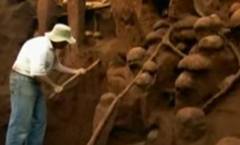 A man next to the enormous anthill